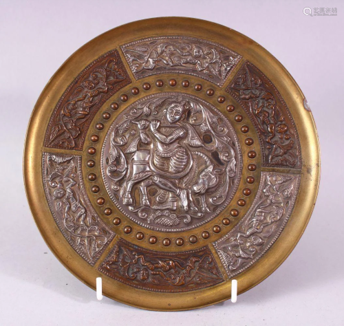 AN INDIAN BRASS CIRCULAR DISH, overlaid with white