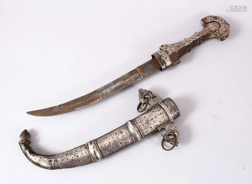 A GOOD EASTERN WHITE METAL JAMBIYA DAGGER, with onlaid