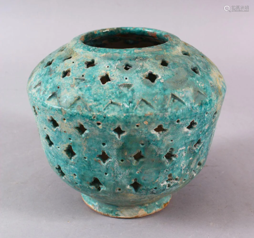A KASHAN TURQUOISE POTTERY OPENWORK VASE, the bod…