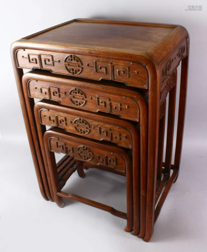 A CHINESE CARVED HARD WOOD NEST OF TABLES. comprising