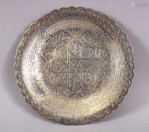 AN ISLAMIC CHASED DECORATED WHITE METAL DISH, the…