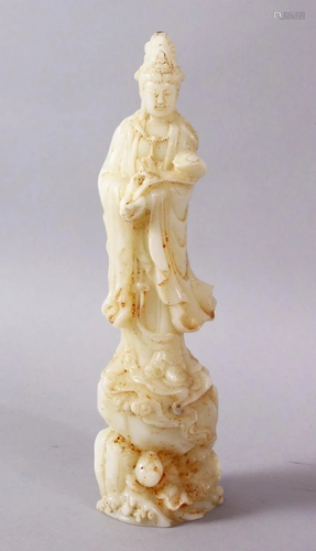 A CHINESE CARVED WHITE JADE FIGURE OF GUANYIN, stood