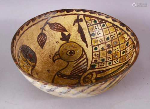 AN EARLY ISLAMIC POTTERY BOWL painted to the interior