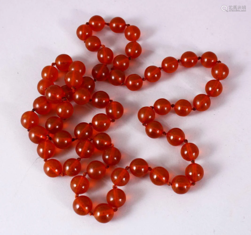 A 19TH CENTURY SET OF CARVED AMBER PRAYER BEADS, in the