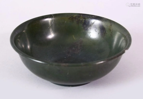 A PLAIN CHINESE CIRCULAR JADE BOWL, with mottled