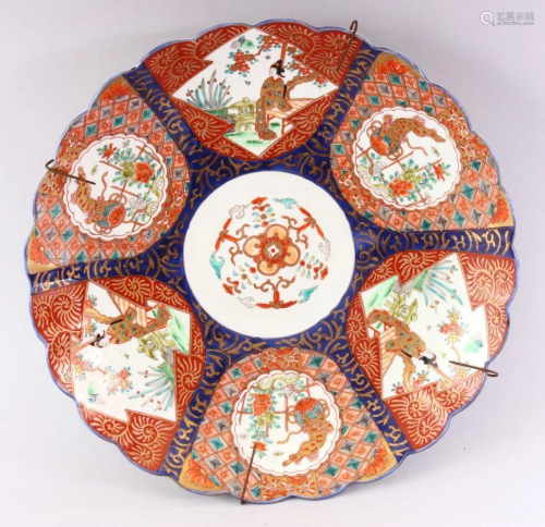 A JAPANESE IMARI CHARGER, with shaped edge, painted