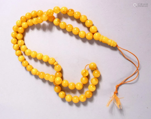 A CHINESE QING DYNASTY CARVED AMBER PRAYER BEADS /