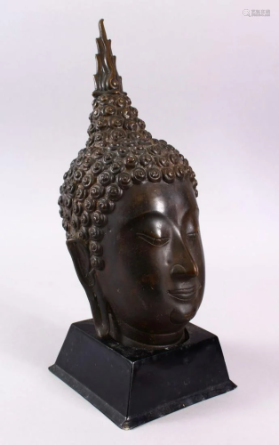 A THAI BRONZE FIGURE OF A HEAD, upon a fitted stand,
