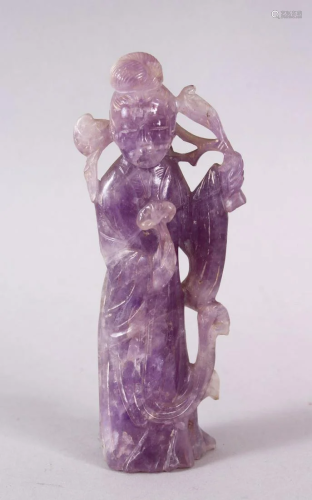 A CHINESE CARVED AMETHYST FIGURE OF GUANYIN, stood