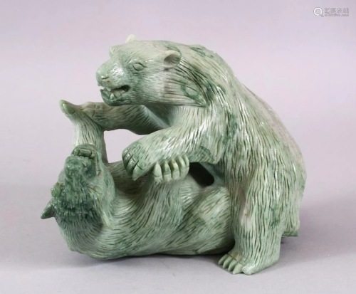 A CHINESE CARVED GREEN HARD STONE MODEL OF TWO PLAYI…