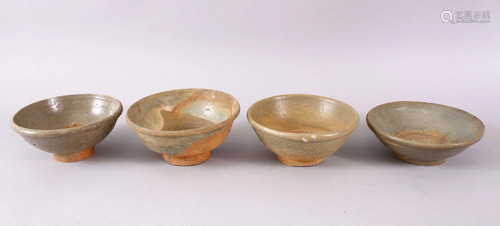 FOUR EARLY CHINESE GREEN GLAZED POTTERY BOWLS, 15m down