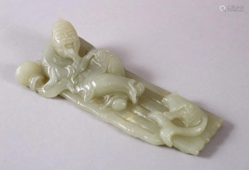 A CHINESE CARVED CELADON JADE FIGURE OF A RECLINED