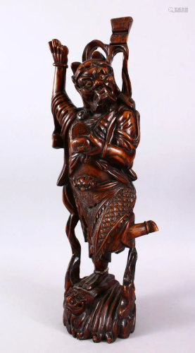 A LARGE 19TH CENTURY CHINESE CARVED HARDWOOD FIG…