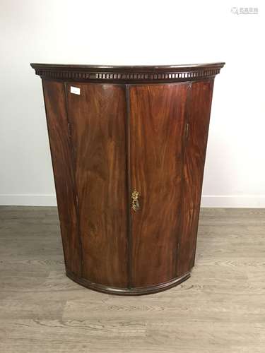 A GEORGE III MAHOGANY BOWFRONT CORNER CUPBOARD