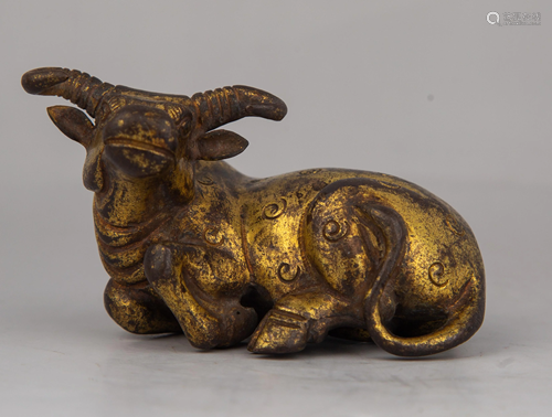 A CARVED GILT-BRONZE BUFFALO