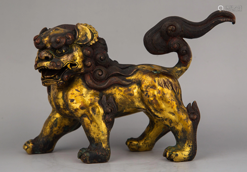 A GILT-BRONZE FIGURE OF LION