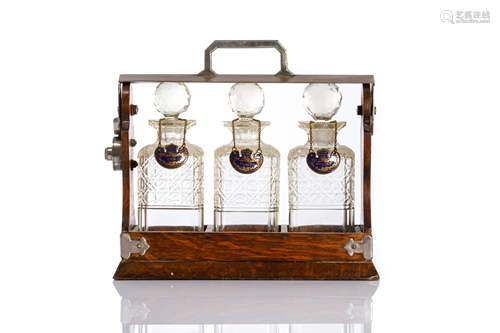 OAK TANTALUS WITH THREE GLASS DECANTERS