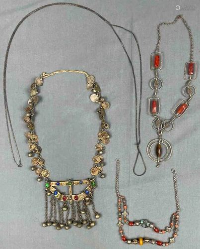 4 chains, necklaces. Probably also silver, stones,