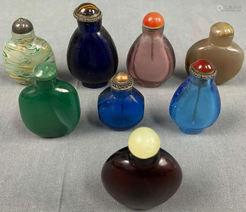 8 snuffbottles. Proably also glass or stone. Probably