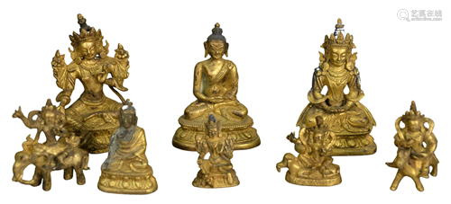 Eight miniature bronze gilt Buddhas, heights 1 1/4