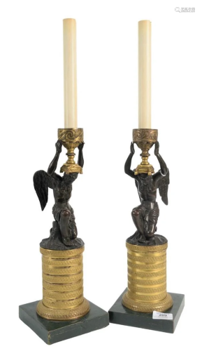 Pair of Bronze Candlesticks having a winged bronze man