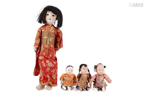 A 20TH CENTURY CHINESE BISQUE HEADED DOLL AND THREE SMALLER ...