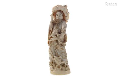 A JAPANESE IVORY CARVING OF A MAN WITH FROGS