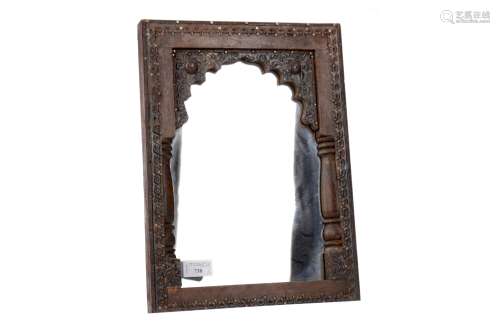 A MOORISH CARVED WOOD FRAMED MIRROR AND A PLATED FLORAL PLAQ...