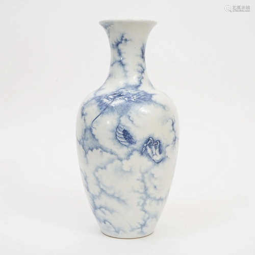 A BLUE AND WHITE DRAGON-DESIGNED VASE