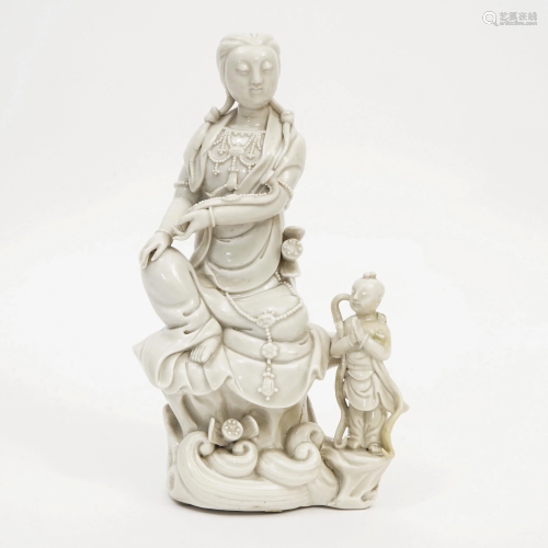 A WHITE PORCELAIN BOY AND GUANYIN STATUE
