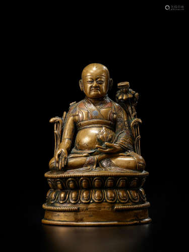 A SILVER AND COPPER INLAID BRASS FIGURE OF LOWO KHENCHEN SON...