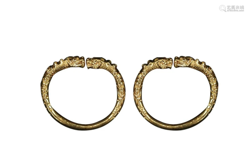 PAIR OF GILT COPPER ALLOY BANGLES CAST WITH DRAGONS