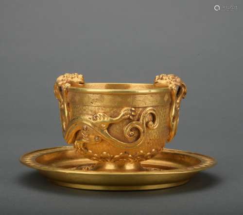 A gold winecup and holder