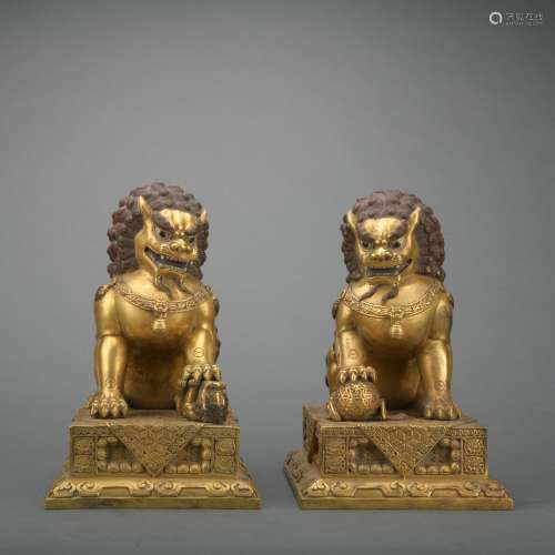 A pair of gilt-bronze lion