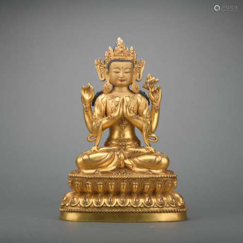 A gilt-bronze statue of Four armed Guanyin