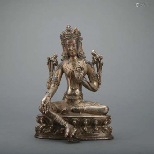 A silver statue of Tara