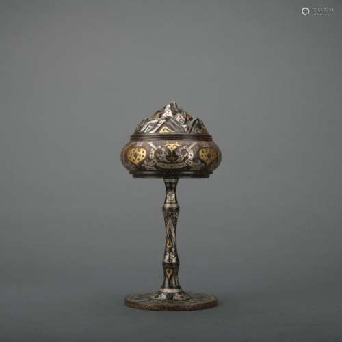 A bronze incense burner ware with gold and silver