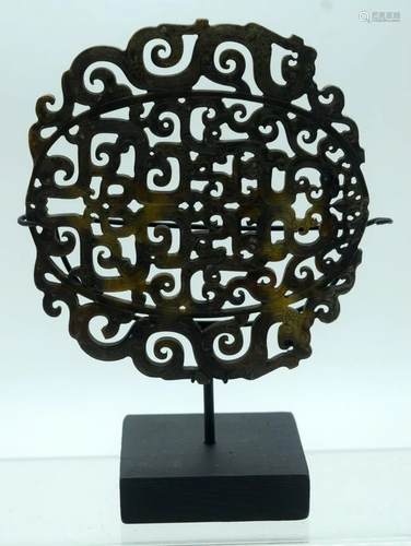 A carved Chinese hardstone plaque on a stand decorated