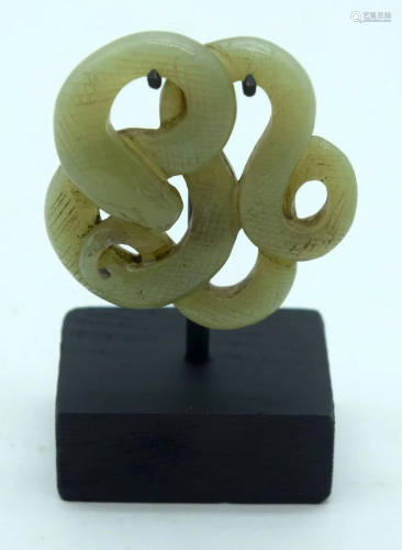 A Chinese Jade plaque on a stand decorated with a snake