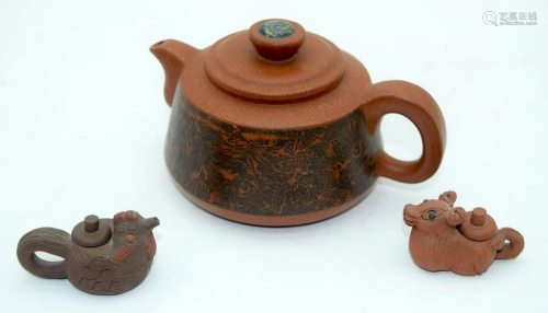 A Yixing teapot decorated with a landscape together