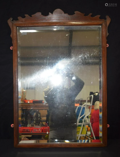 A large wooden framed mirror with bevelled glass 100 x