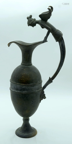 A bronze water/wine jug with an unusual winged woman