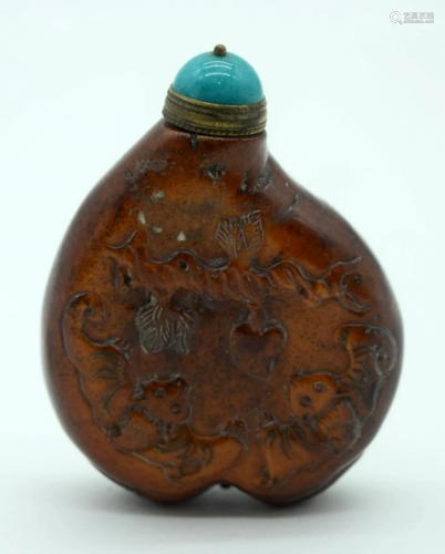 A Chinese Snuff bottle decorated in relief with a tiger