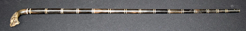 A Chinese wood walking stick with a carved handle in