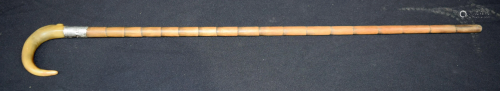 A Buffalo Horn walking cane with a silver collar 90cm.