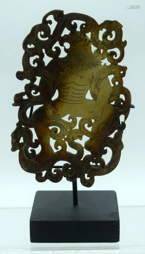 A carved hardstone plaque decorated with a bird and