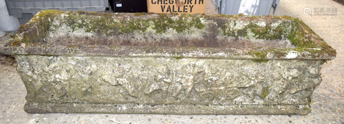 A large cast stone rectangular plater decorated with