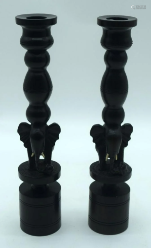 A pair of carved Ebony elephant candle stick holders