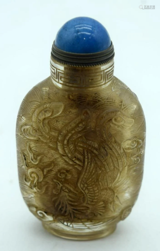 A Chinese glass snuff bottle carved with a dragon 10cm
