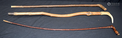 A carved antler horn walking cane together with 2 other